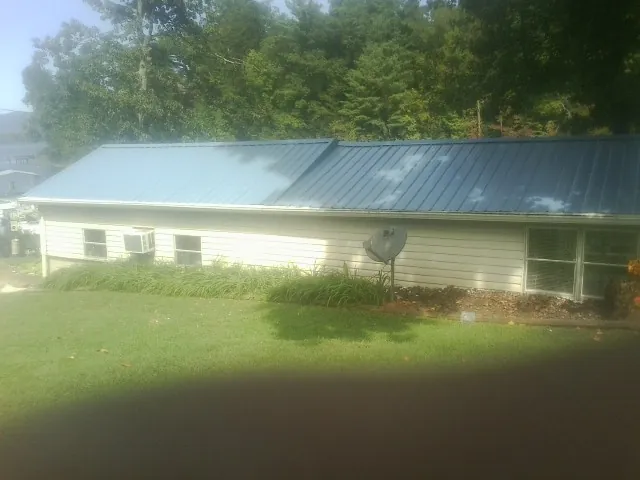 Blue metal roof running the length of a single story home in Brownville